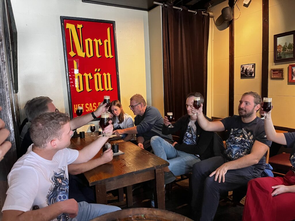 Docbyte team members raising glasses during a team-building day in Mechelen